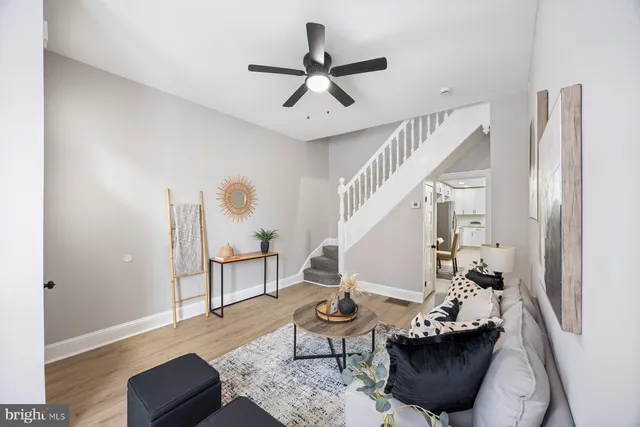 a living room with furniture and a potted plant