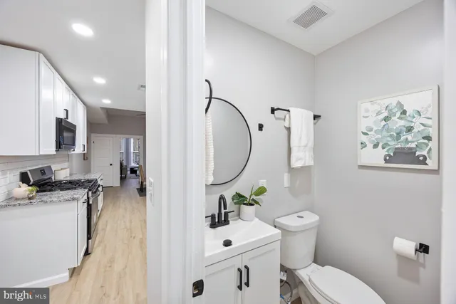 a bathroom with a sink toilet and mirror