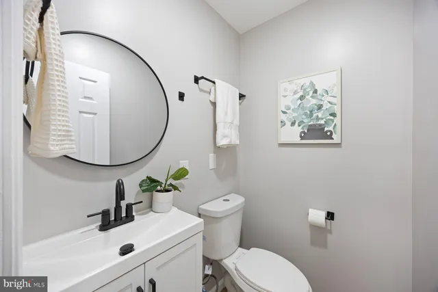 a bathroom with a sink mirror and toilet