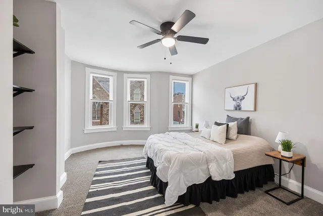 a bedroom with bed and a window