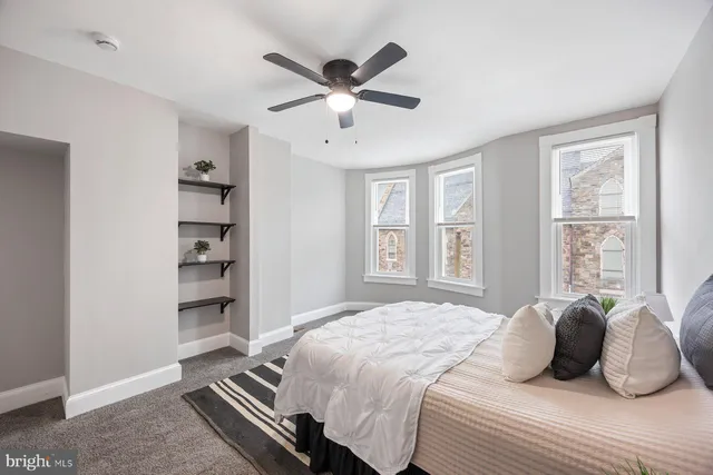 a bedroom with a large bed and a window