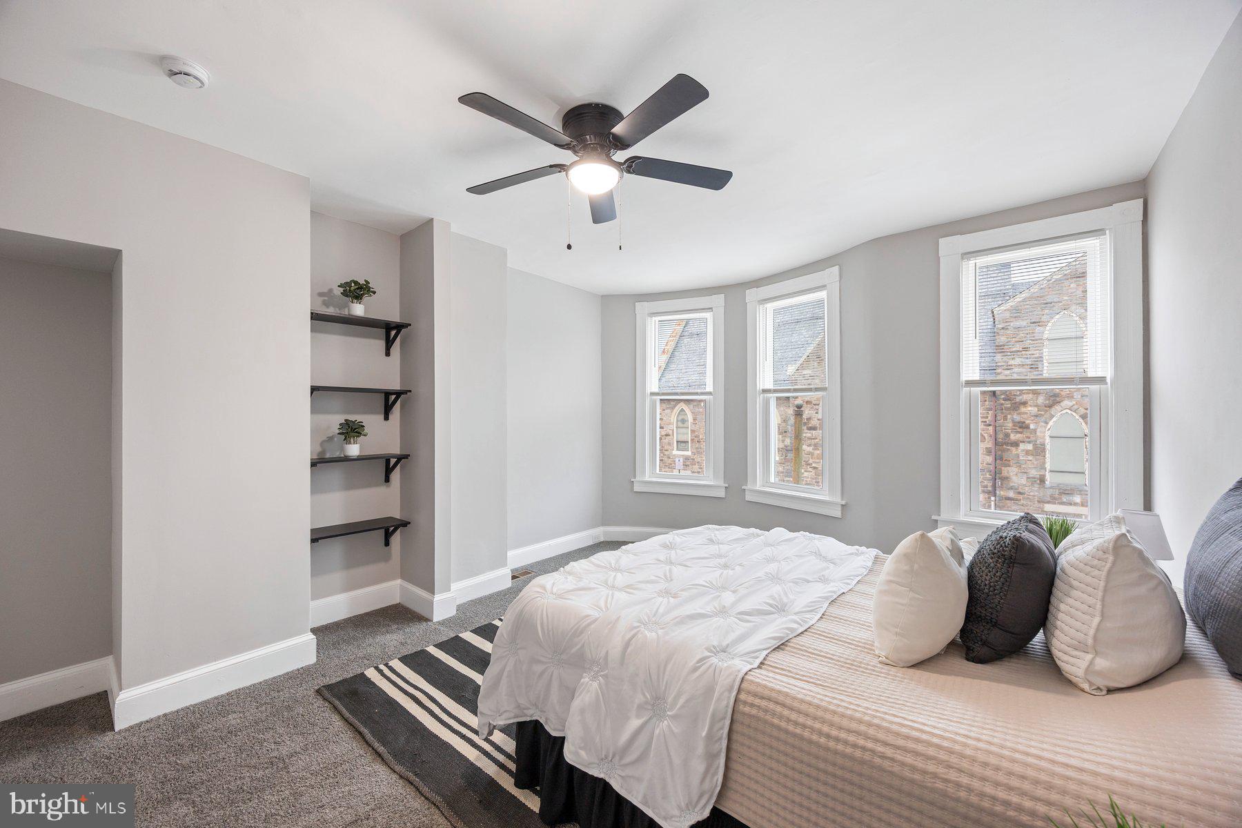 3611 Chestnut Avenue Baltimore, MD 21211 - Photo 22 of 38 a bedroom with a large bed and a window