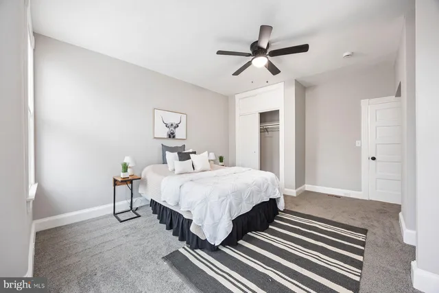 a spacious bedroom with a bed and a chandelier