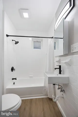 a bathroom with a bathtub and a sink
