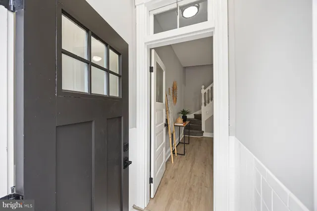 a view of a hallway and a livingroom with furniture