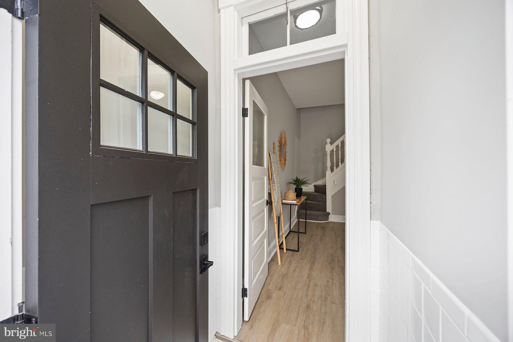 3611 Chestnut Avenue Baltimore, MD 21211 - Photo 4 of 38 a view of a hallway and a livingroom with furniture