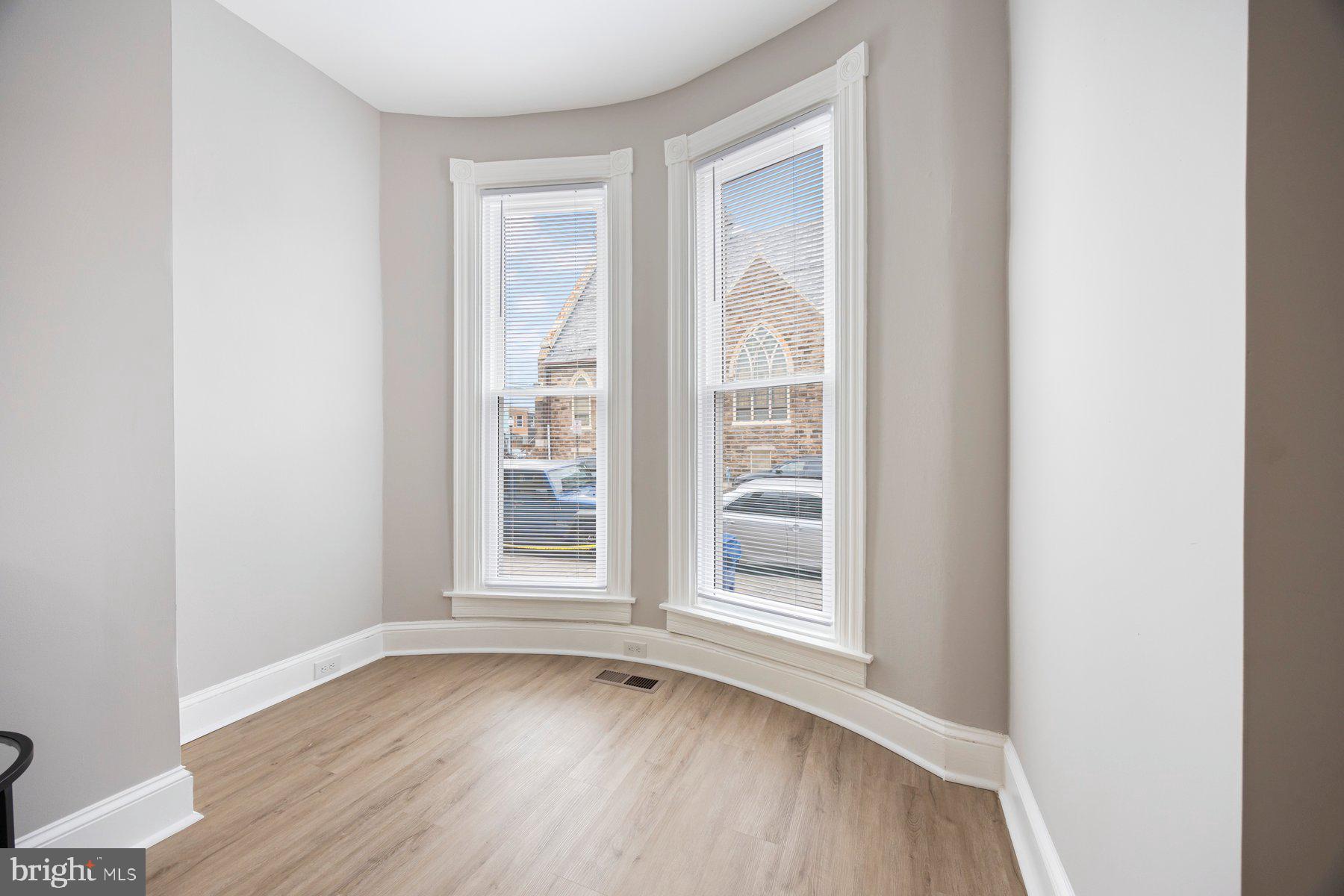 3611 Chestnut Avenue Baltimore, MD 21211 - Photo 8 of 38 an empty room with wooden floor and windows