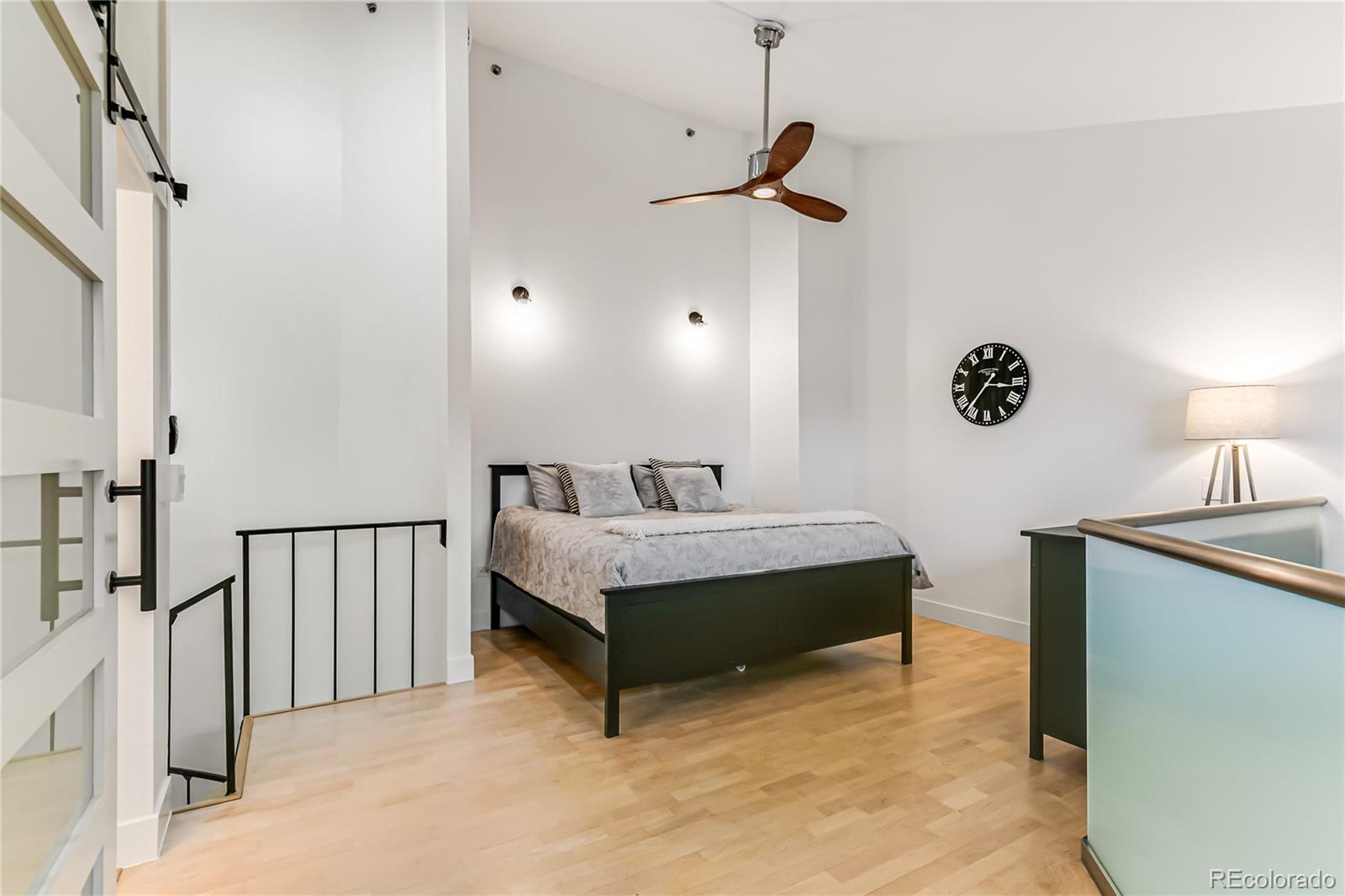 350 Detroit Street, Unit 413 Denver, CO 80206 - Photo 11 of 25 a room with a bed and a chandelier