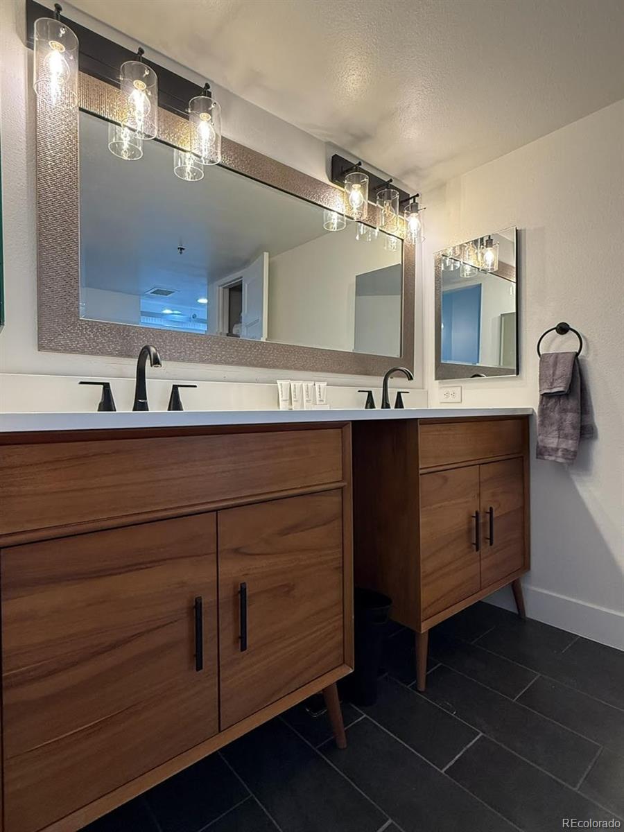 350 Detroit Street, Unit 413 Denver, CO 80206 - Photo 12 of 25 a bathroom with a sink and a mirror