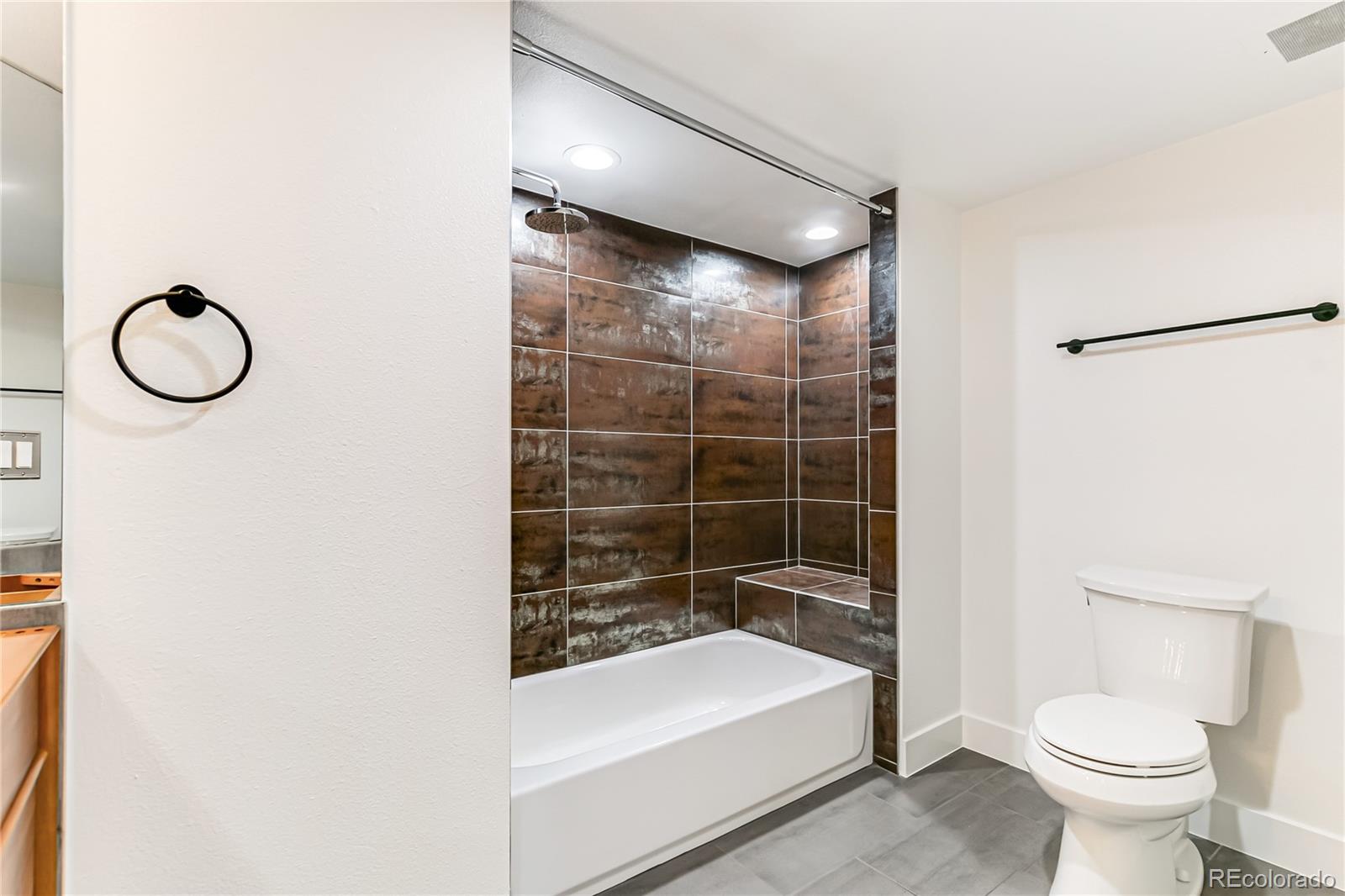 350 Detroit Street, Unit 413 Denver, CO 80206 - Photo 19 of 25 a bathroom with a toilet sink and shower