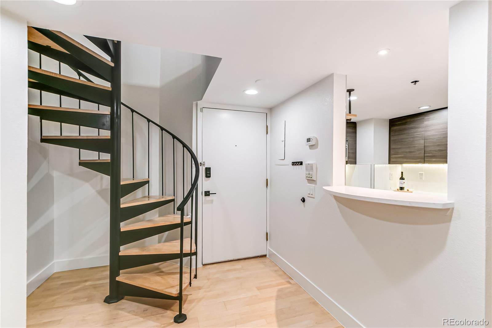 350 Detroit Street, Unit 413 Denver, CO 80206 - Photo 3 of 25 a view of entryway with wooden floor and livingroom view