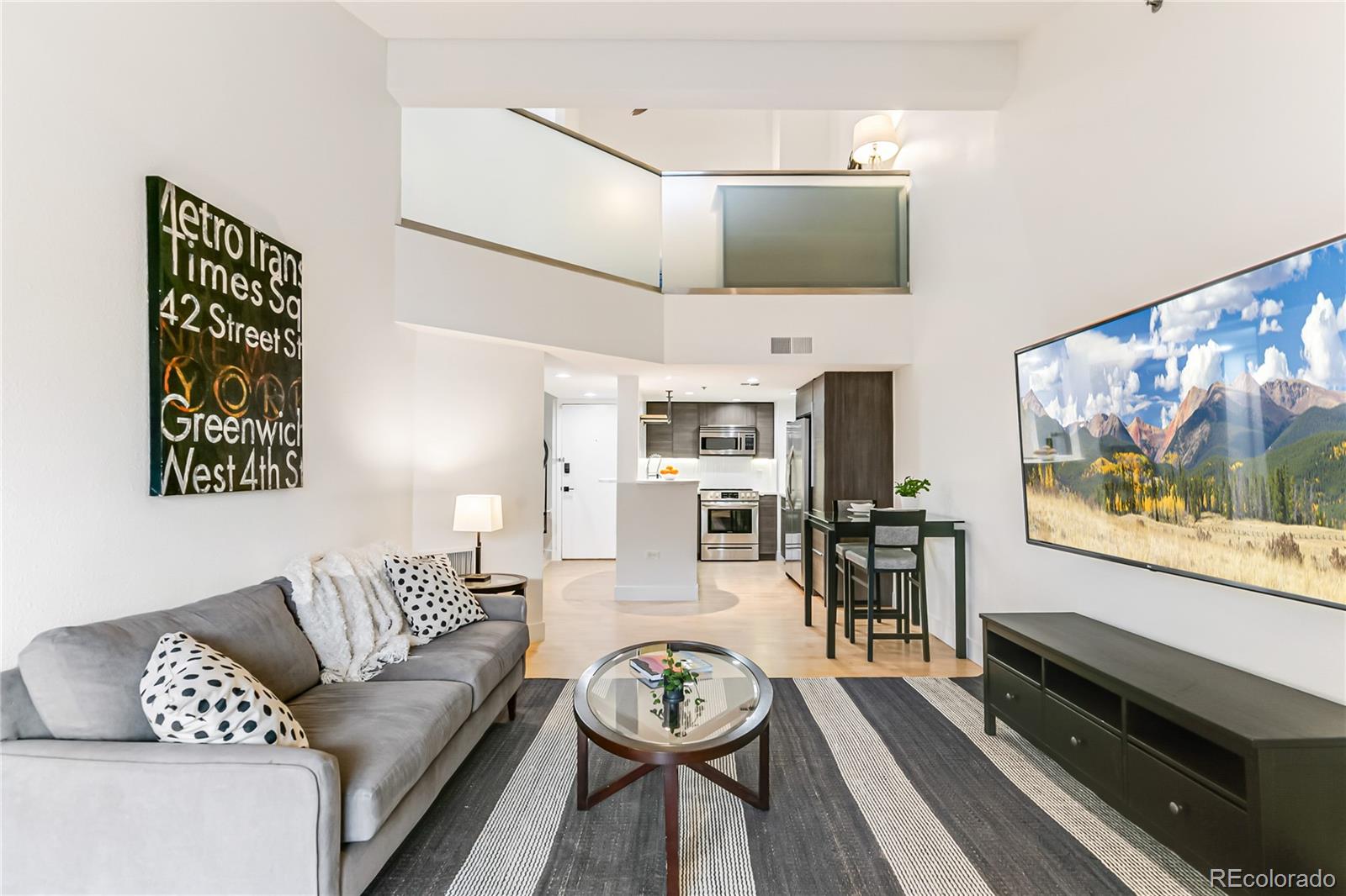 350 Detroit Street, Unit 413 Denver, CO 80206 - Photo 4 of 25 a living room with furniture and a flat screen tv