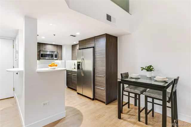 a kitchen with stainless steel appliances a refrigerator and a stove