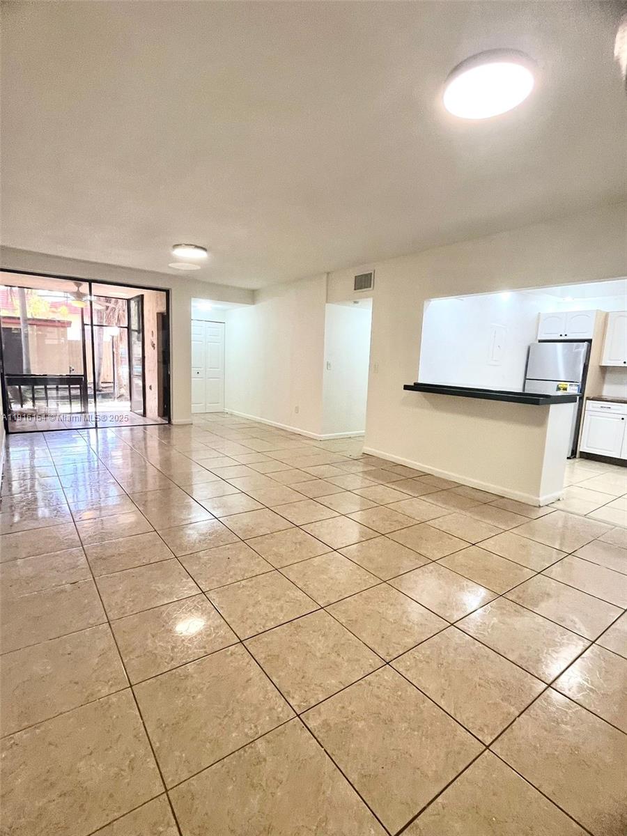 800 Northeast 199th Street, Unit 106D Miami, FL 33179 - Photo 1 of 20 a view of an empty room with a window