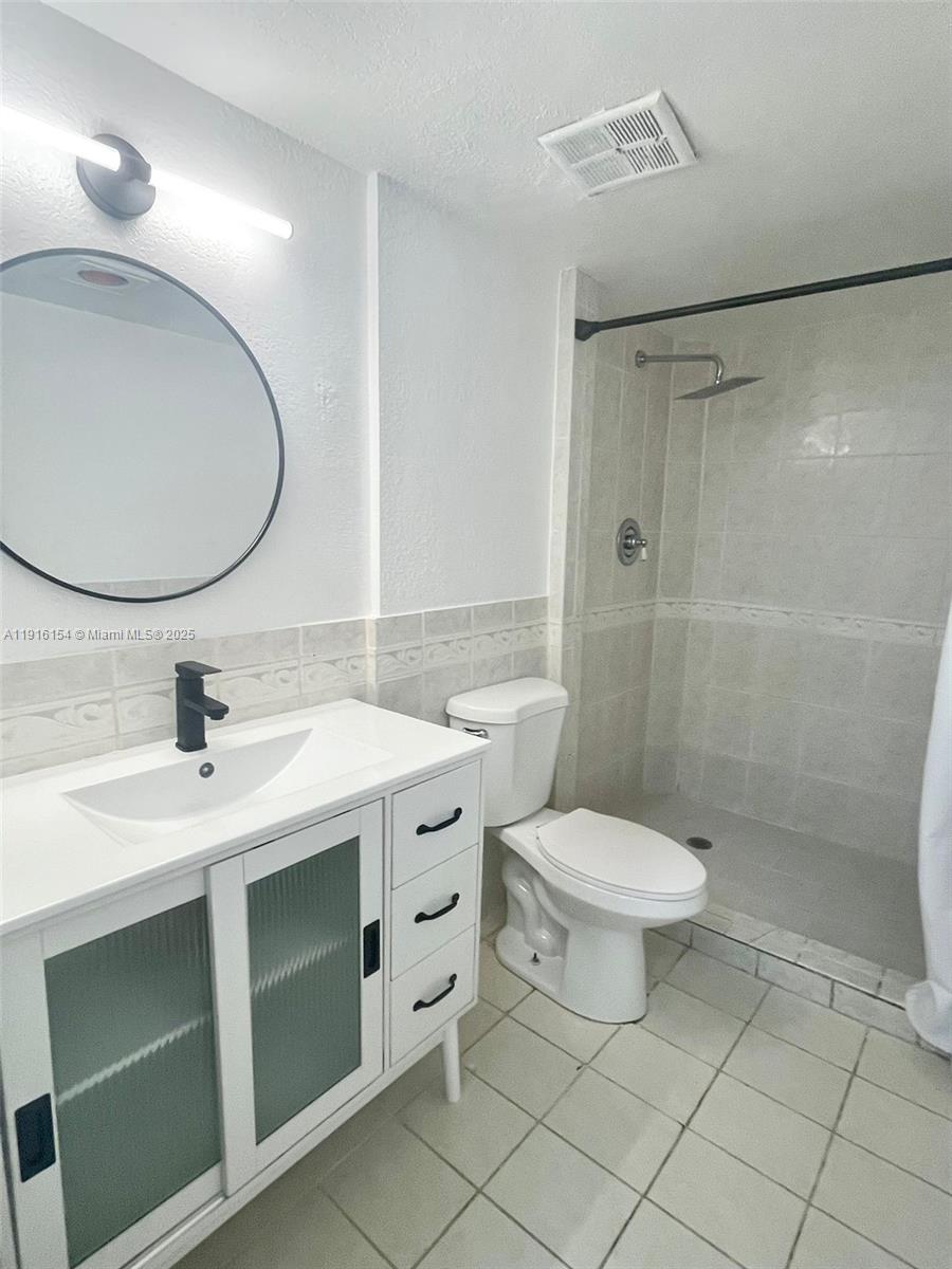 800 Northeast 199th Street, Unit 106D Miami, FL 33179 - Photo 12 of 20 a bathroom with a sink toilet and shower