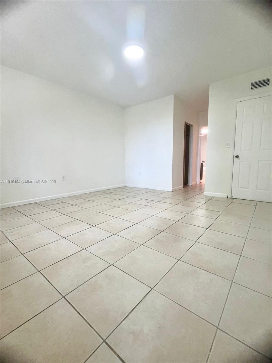 800 Northeast 199th Street, Unit 106D Miami, FL 33179 - Photo 14 of 20 a view of an empty room and window