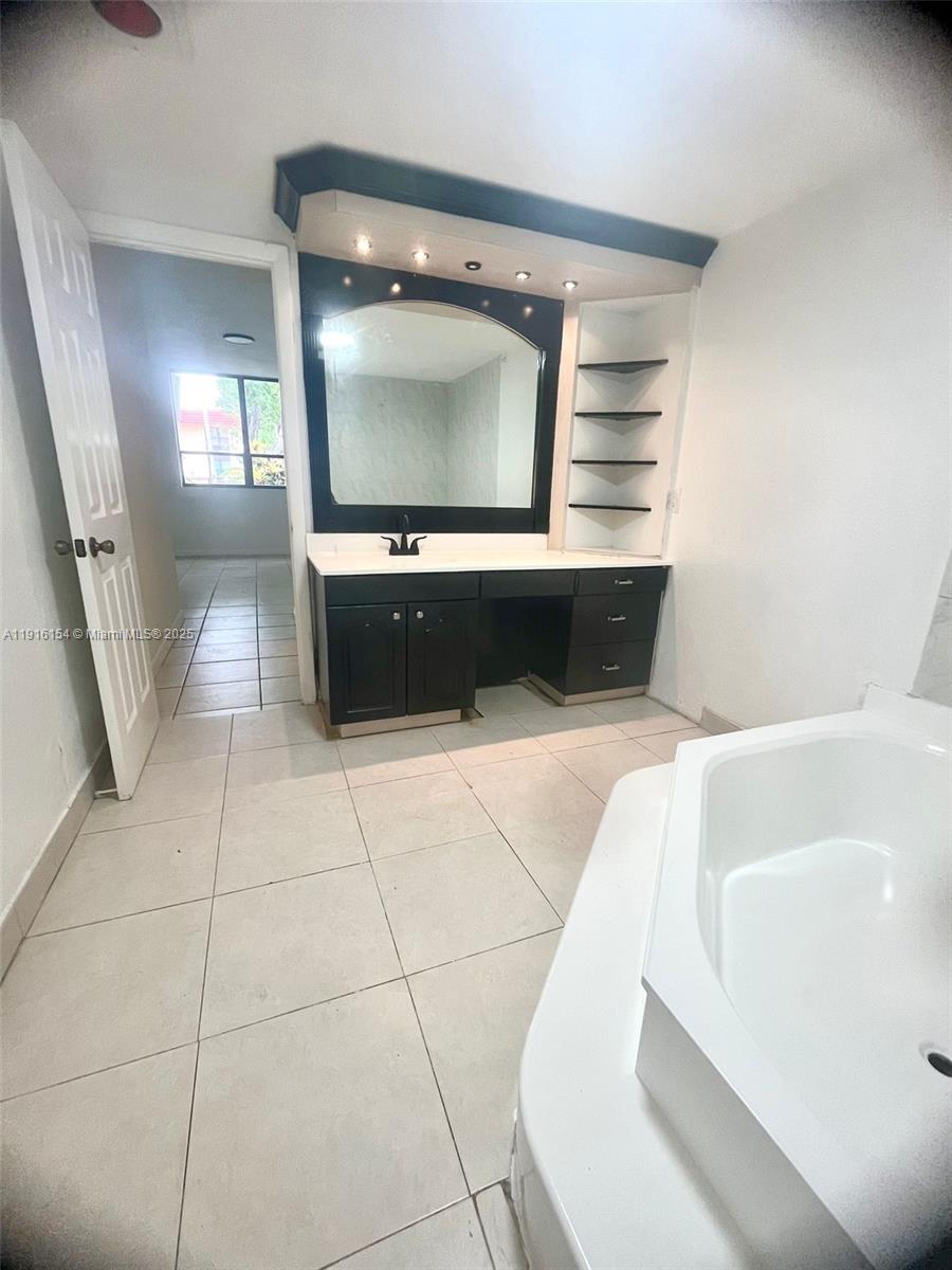 800 Northeast 199th Street, Unit 106D Miami, FL 33179 - Photo 16 of 20 a living room with a couch and a flat screen tv