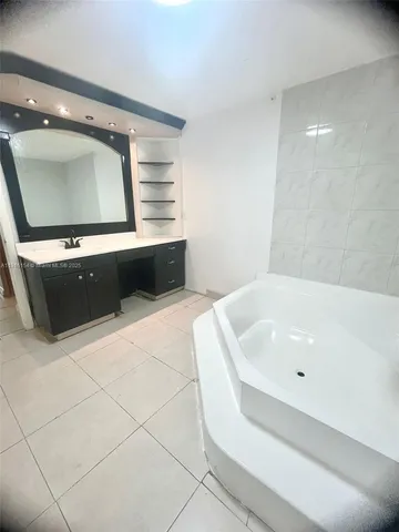 a bathroom with a bathtub and a sink