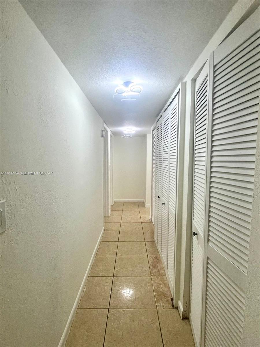 800 Northeast 199th Street, Unit 106D Miami, FL 33179 - Photo 8 of 20 a view of a hallway