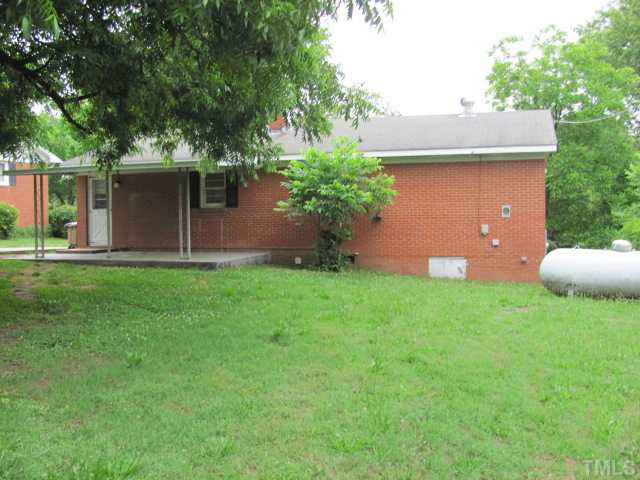 222 Forestville Road Wake Forest, NC 27587 - Photo 18 of 18 a backyard of a house with plants and a tree