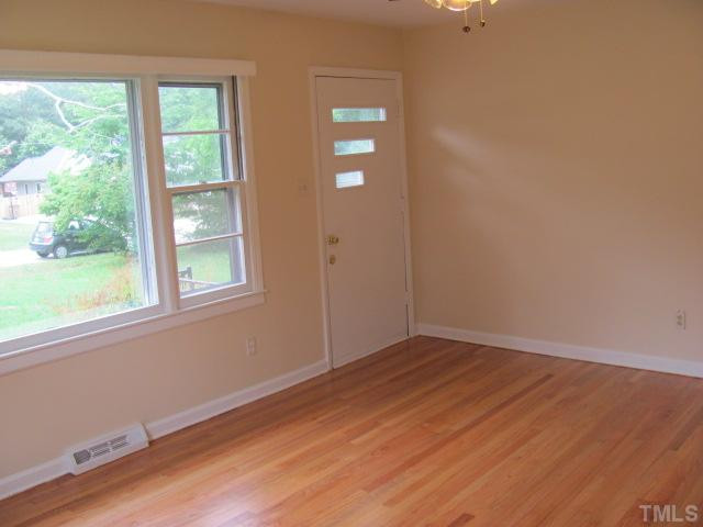 222 Forestville Road Wake Forest, NC 27587 - Photo 3 of 18 an empty room with wooden floor and windows
