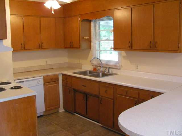 222 Forestville Road Wake Forest, NC 27587 - Photo 4 of 18 a kitchen with a sink a stove and cabinets