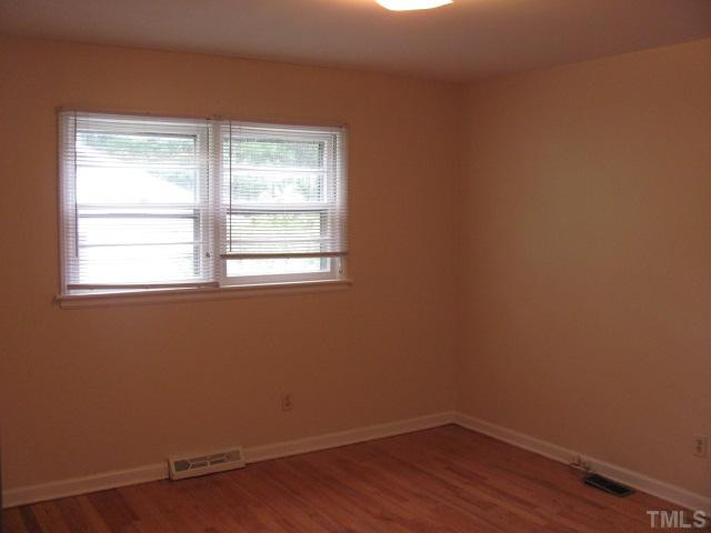 222 Forestville Road Wake Forest, NC 27587 - Photo 7 of 18 a view of a small space with wooden floor and a window