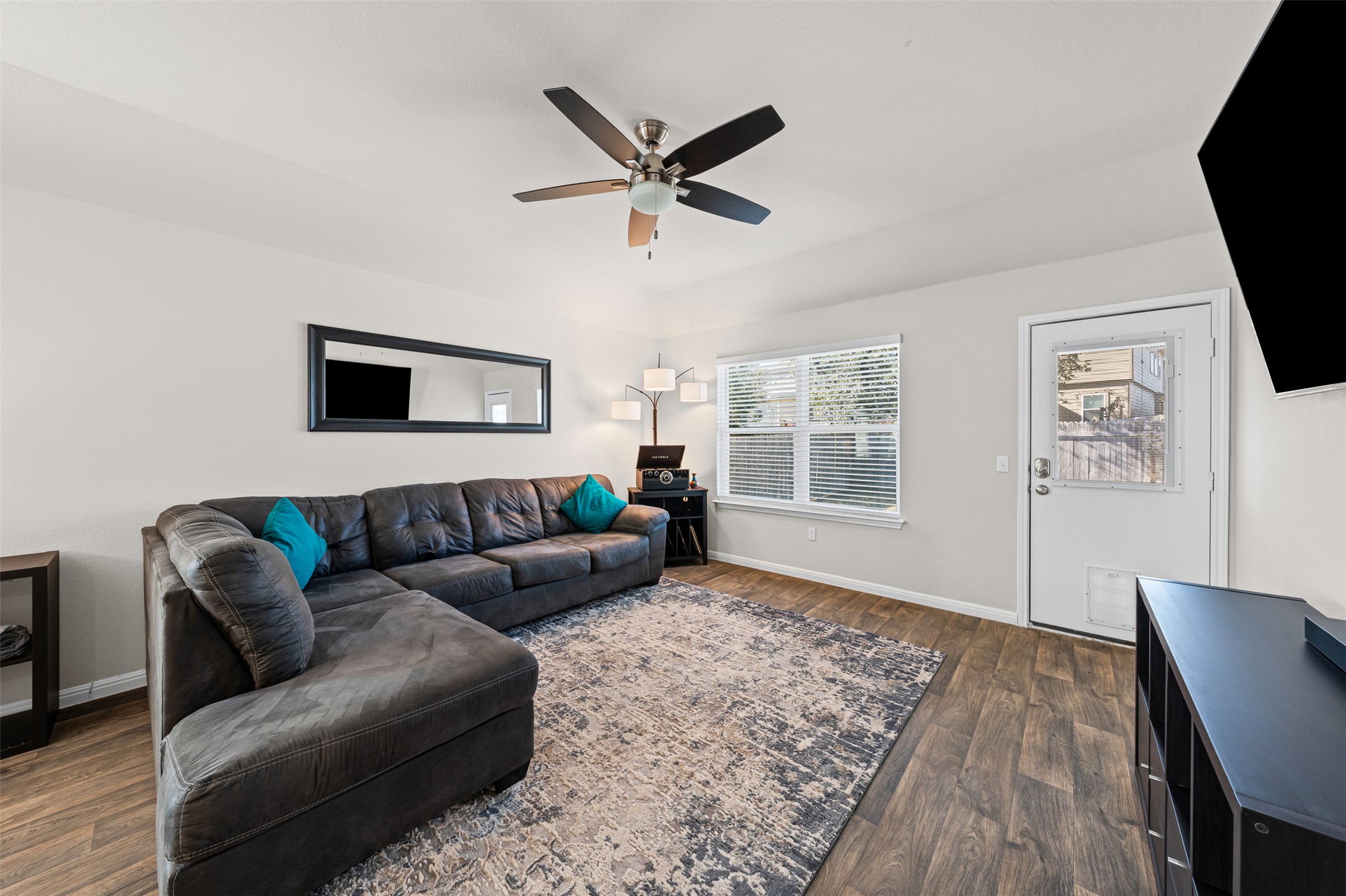 132 Dunlin Lane Leander, TX 78641 - Photo 12 of 34 Living area featuring dark wood-type flooring and a ceiling fan
