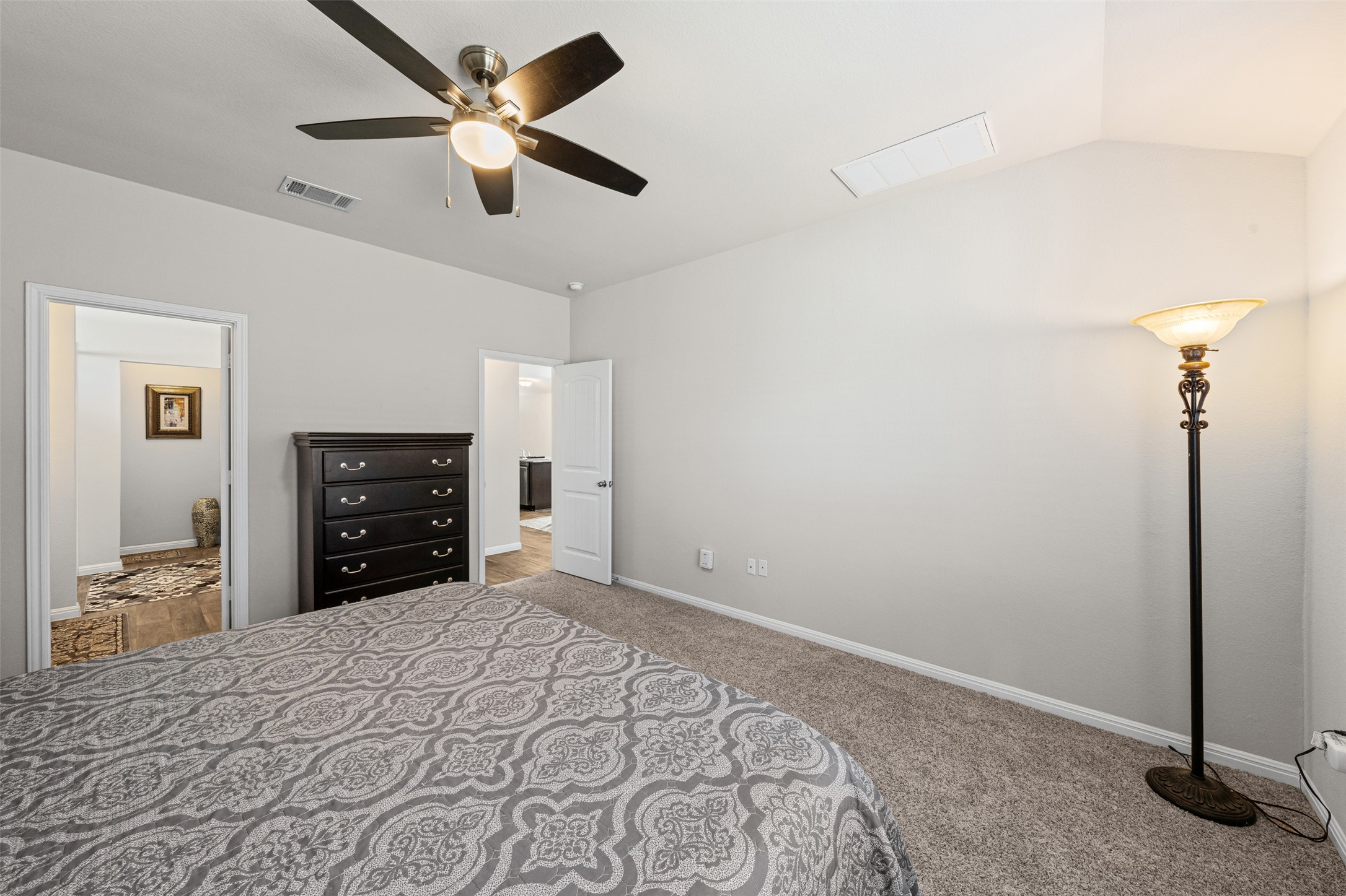 132 Dunlin Lane Leander, TX 78641 - Photo 16 of 34 Bedroom featuring a ceiling fan, light colored carpet, and vaulted ceiling