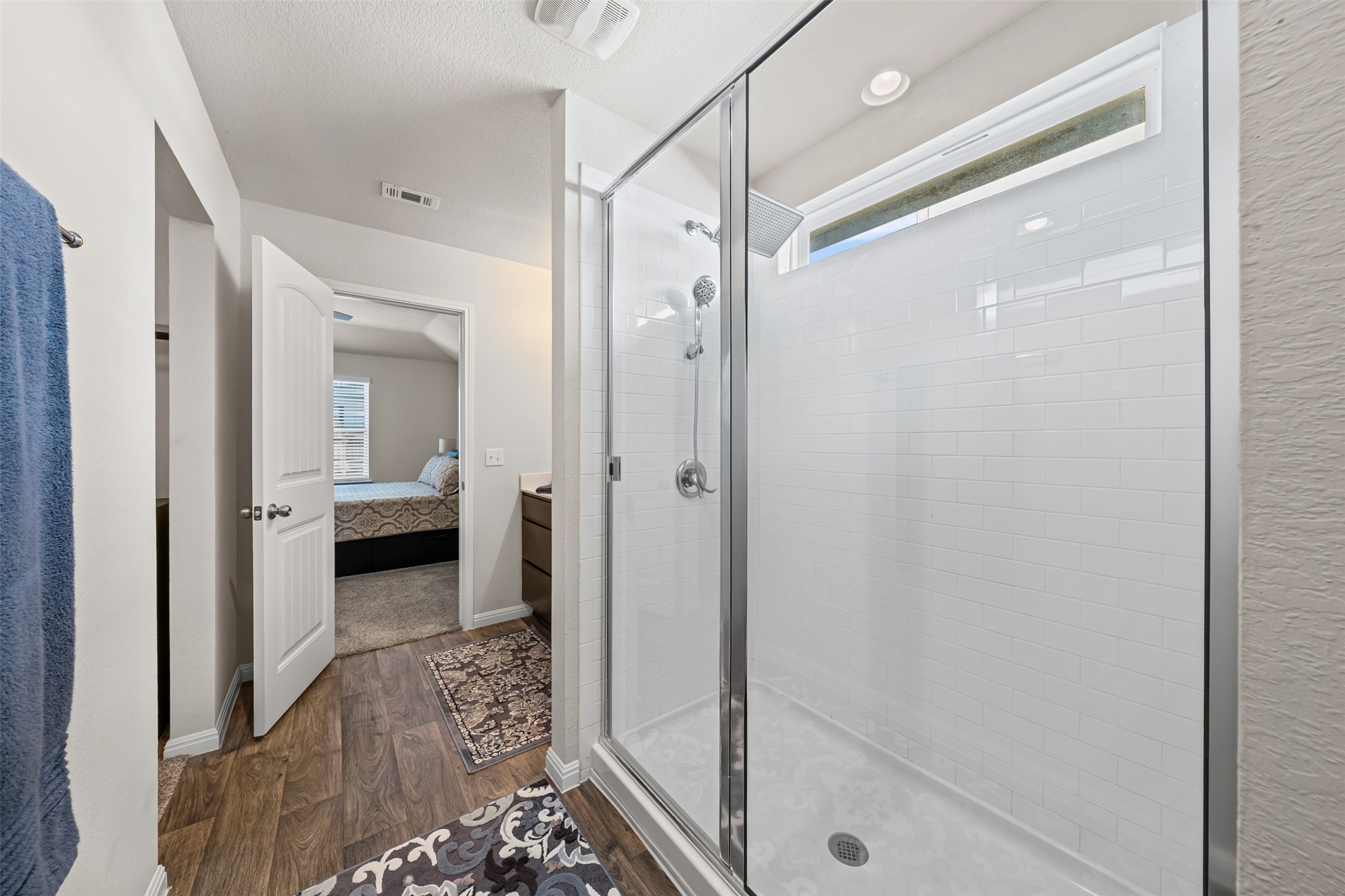 132 Dunlin Lane Leander, TX 78641 - Photo 18 of 34 Ensuite bathroom featuring a shower stall and dark wood-style floors