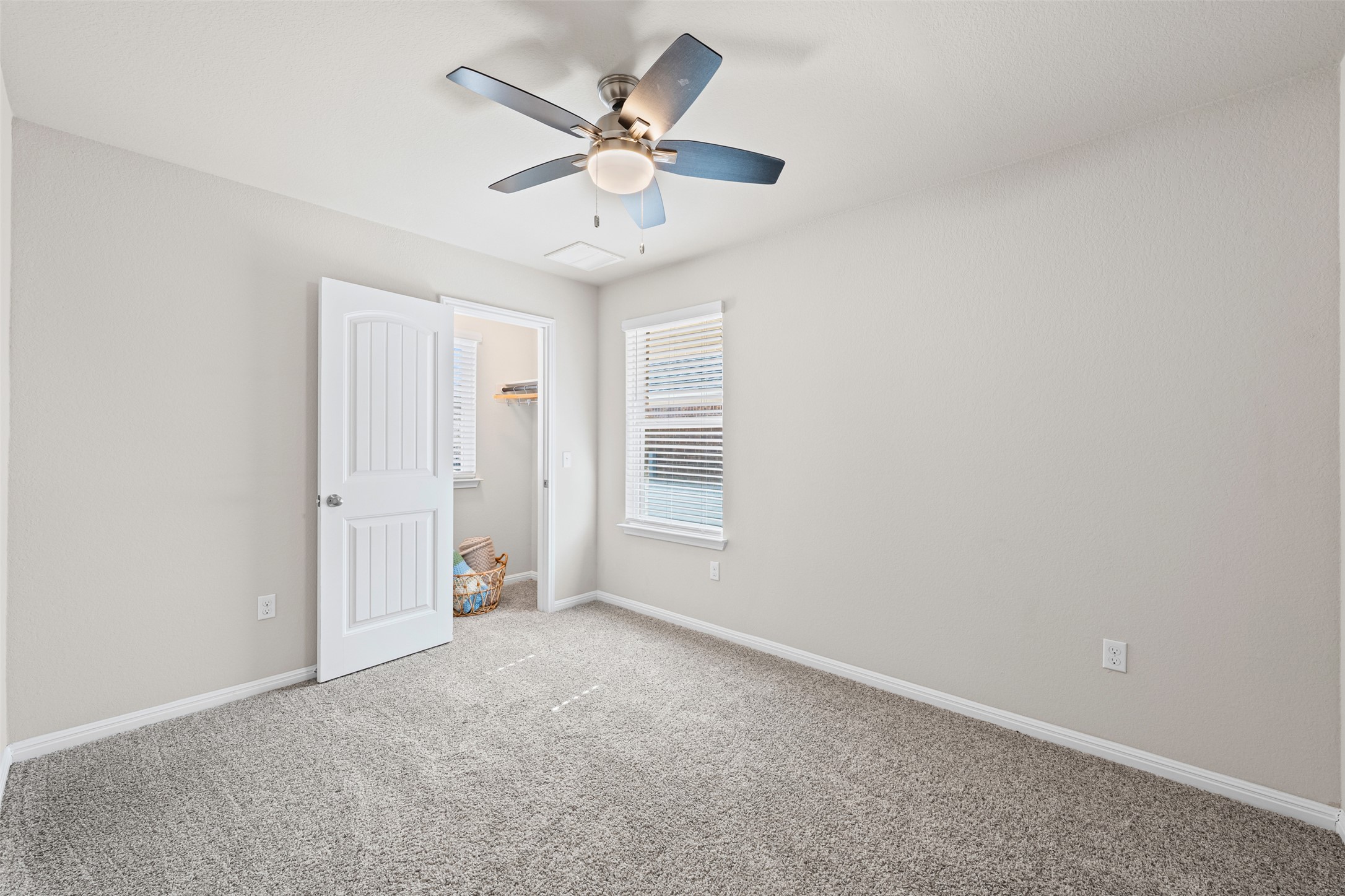 132 Dunlin Lane Leander, TX 78641 - Photo 20 of 34 Unfurnished bedroom featuring carpet floors, a ceiling fan, and a closet