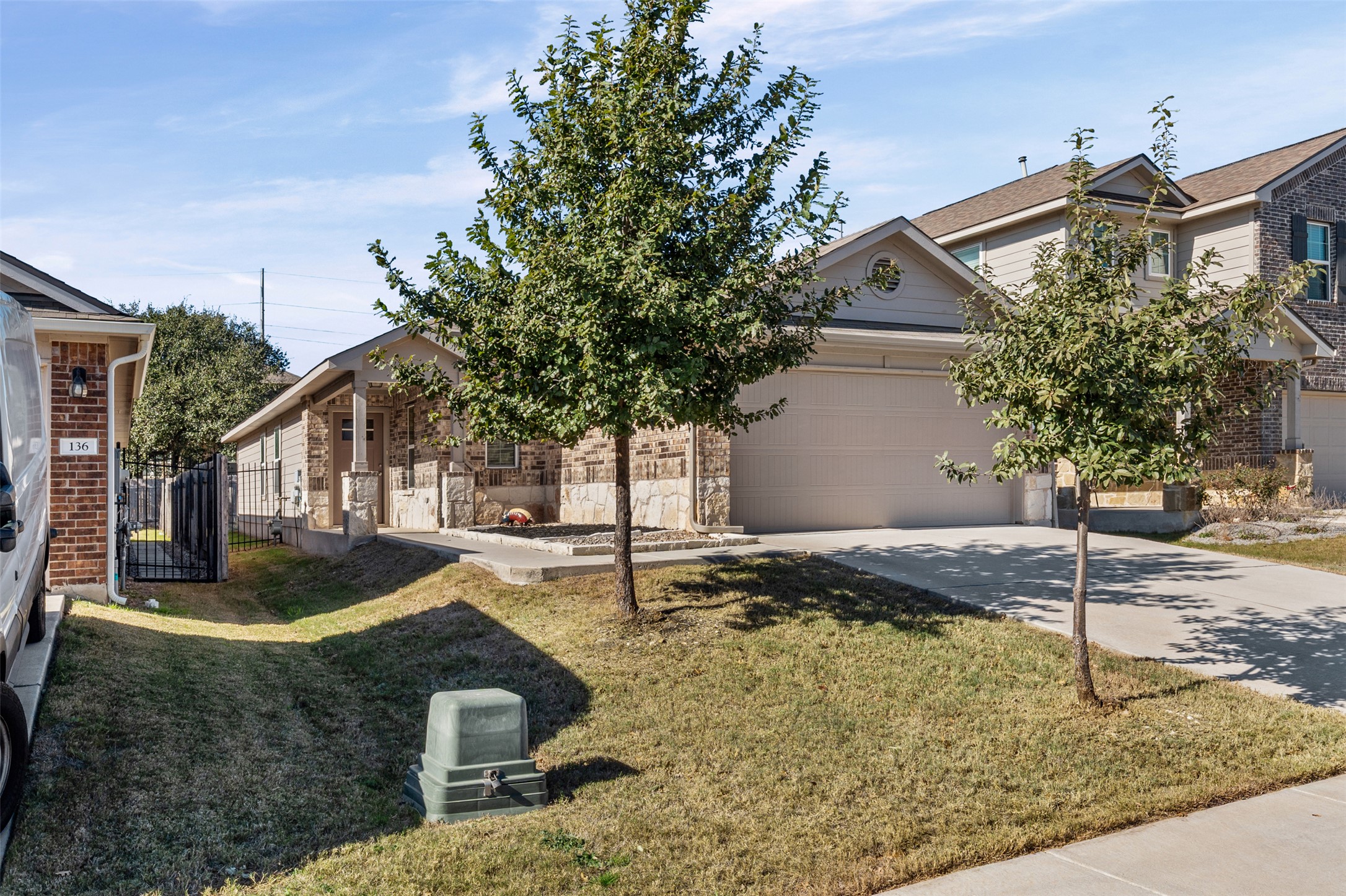 132 Dunlin Lane Leander, TX 78641 - Photo 2 of 34 View of front of property with driveway, an attached garage, and stone siding