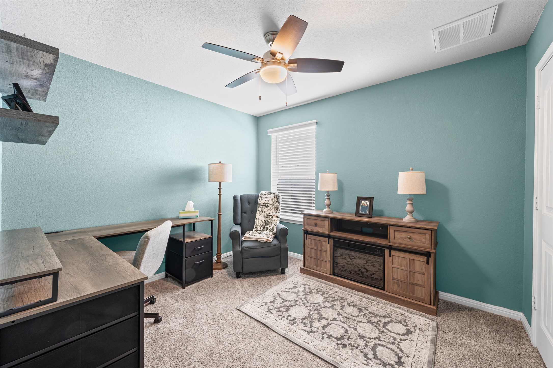 132 Dunlin Lane Leander, TX 78641 - Photo 22 of 34 Office area featuring light colored carpet, a ceiling fan, and a textured ceiling