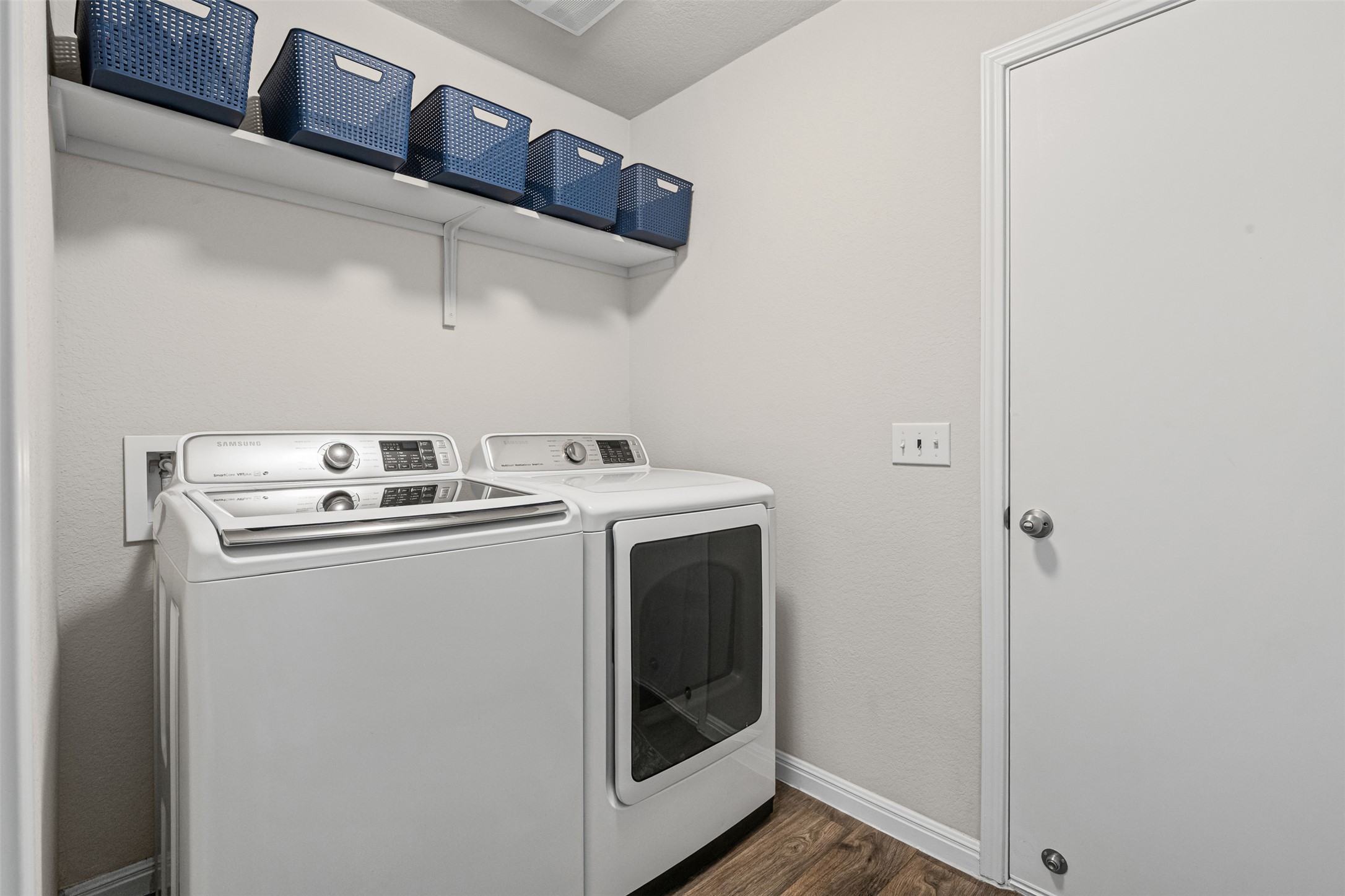 132 Dunlin Lane Leander, TX 78641 - Photo 23 of 34 Laundry area featuring washer and clothes dryer and dark wood finished floors