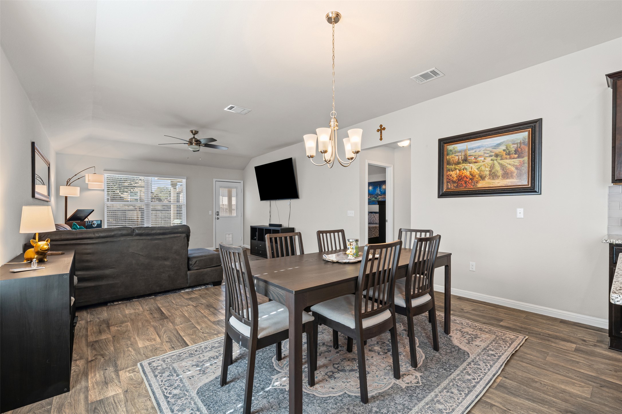 132 Dunlin Lane Leander, TX 78641 - Photo 9 of 34 Dining room featuring ceiling fan, a chandelier, and dark wood-type flooring