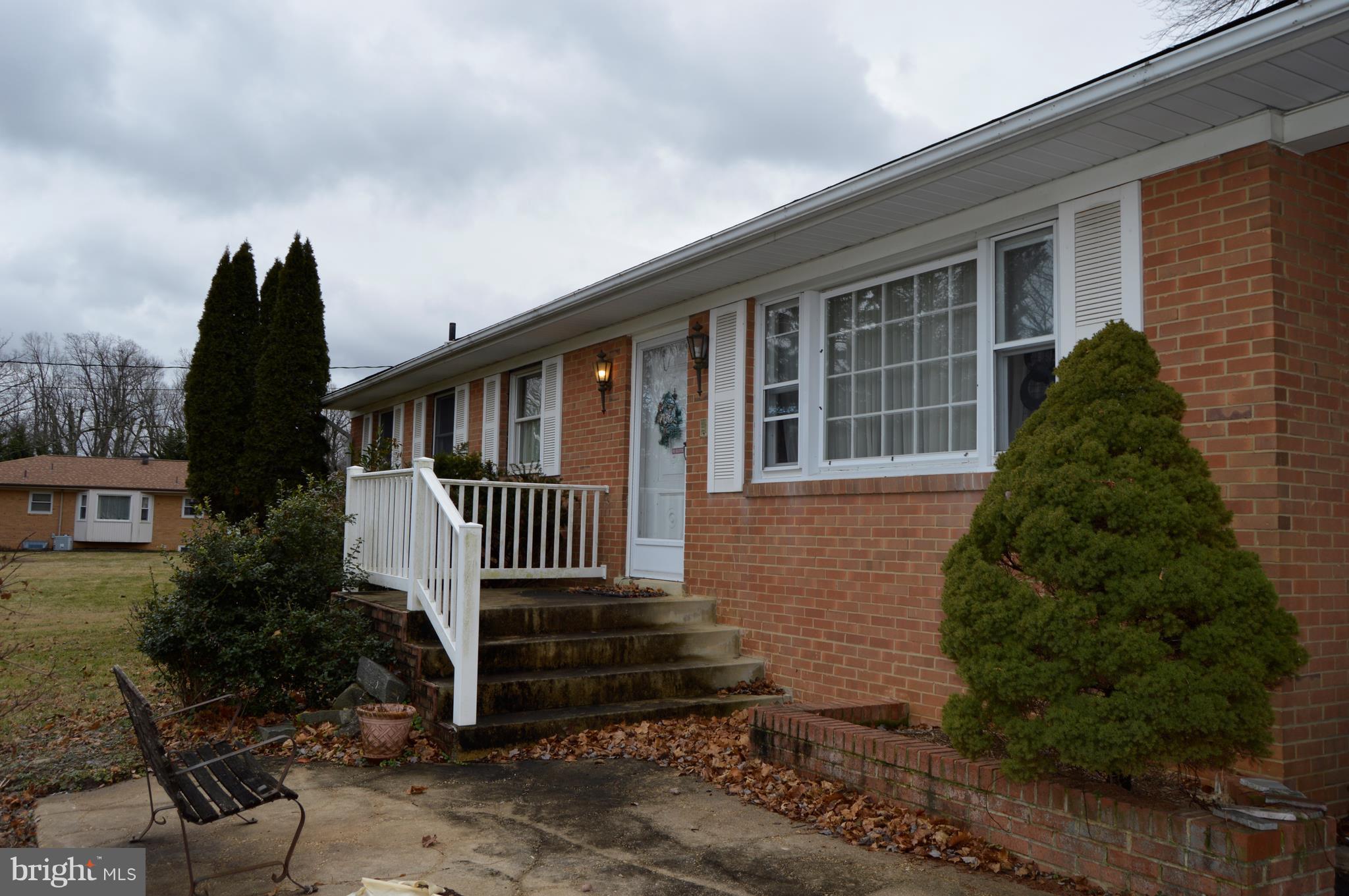 15510 Peach Orchard Road Silver Spring, MD 20905 - Photo 2 of 9 a front view of a house with a garden