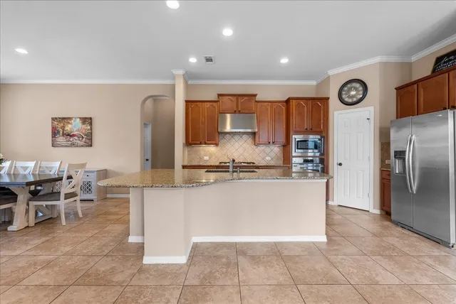 a kitchen with stainless steel appliances granite countertop a sink and a stove