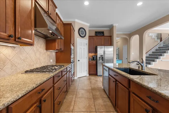 a kitchen with stainless steel appliances granite countertop a sink and cabinets