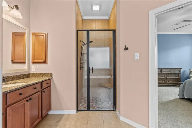 a bathroom with a tub shower and sink