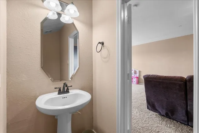 a living room with furniture a couch and a chandelier