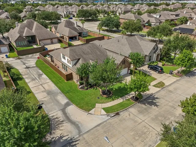 an aerial view of multiple houses with yard