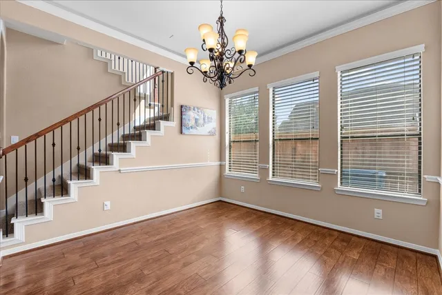 a view of a living room and kitchen with wooden floor