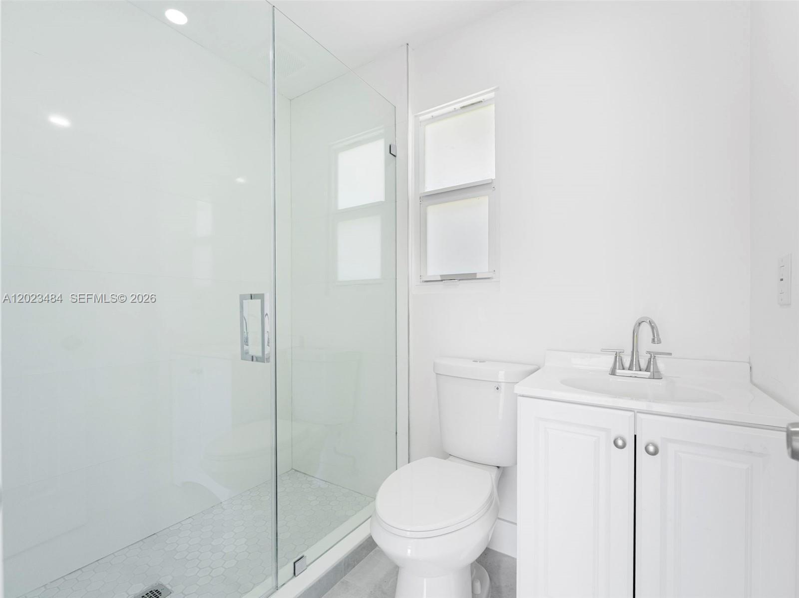 1961 Rutland Street Opa-Locka, FL 33054 - Photo 25 of 33 a bathroom with a toilet sink vanity and shower