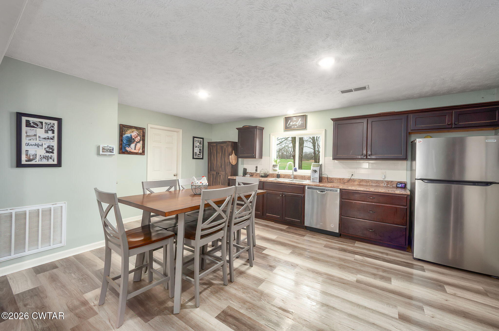 919 Bratt Thomas Road Brownsville, TN 38012 - Photo 12 of 29 a kitchen with stainless steel appliances kitchen island granite countertop a refrigerator a stove a sink dishwasher with a dining table and chairs