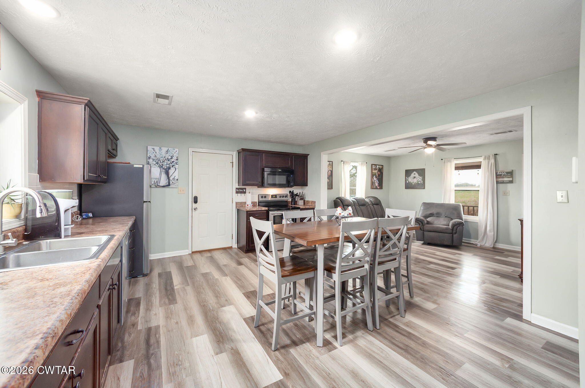 919 Bratt Thomas Road Brownsville, TN 38012 - Photo 14 of 29 a view of a dining room with furniture window and wooden floor