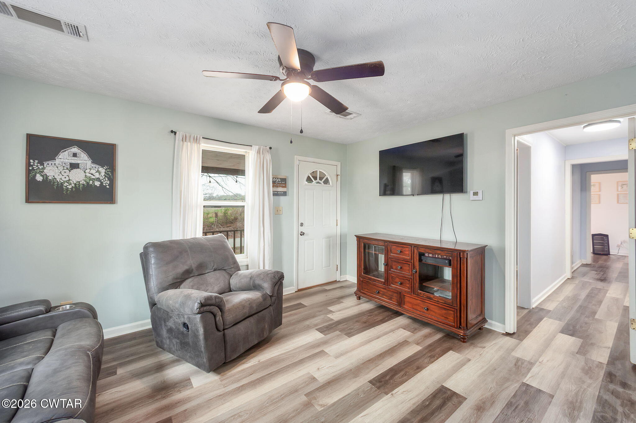 919 Bratt Thomas Road Brownsville, TN 38012 - Photo 16 of 29 a living room with furniture a flat screen tv and a fireplace