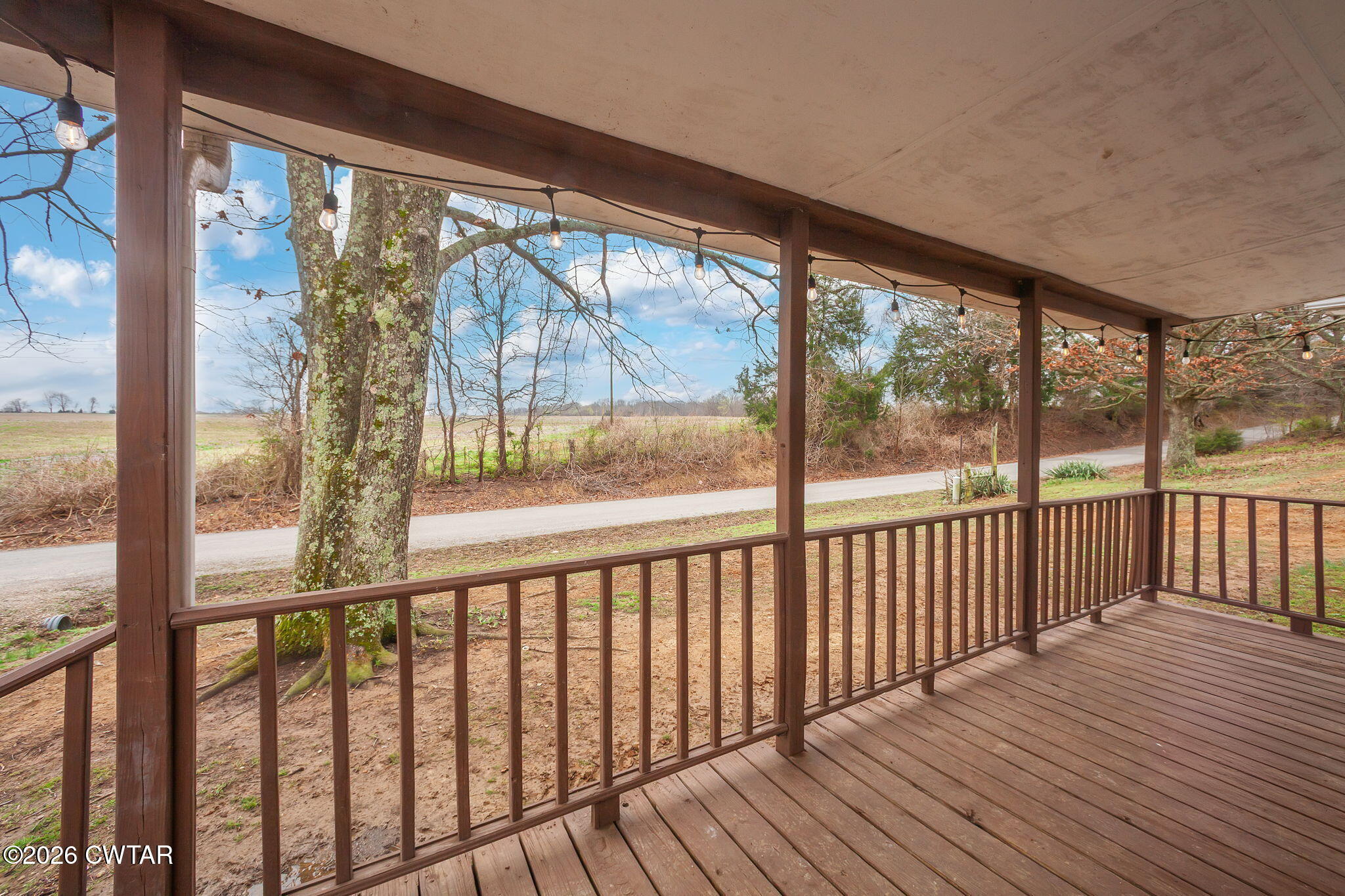 919 Bratt Thomas Road Brownsville, TN 38012 - Photo 2 of 29 a view of a wooden balcony with a chairs