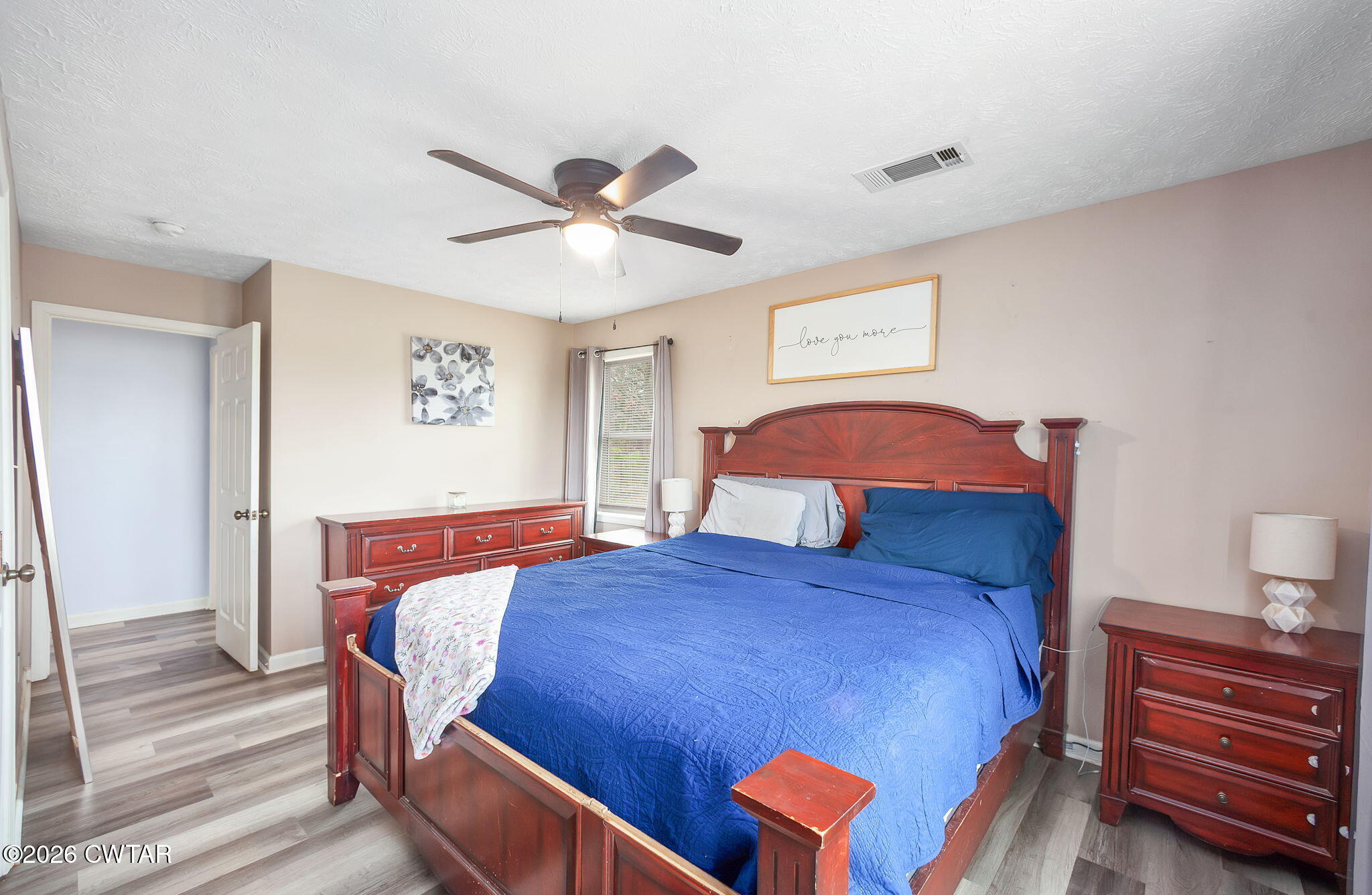 919 Bratt Thomas Road Brownsville, TN 38012 - Photo 24 of 29 a bedroom with a bed and a chandelier