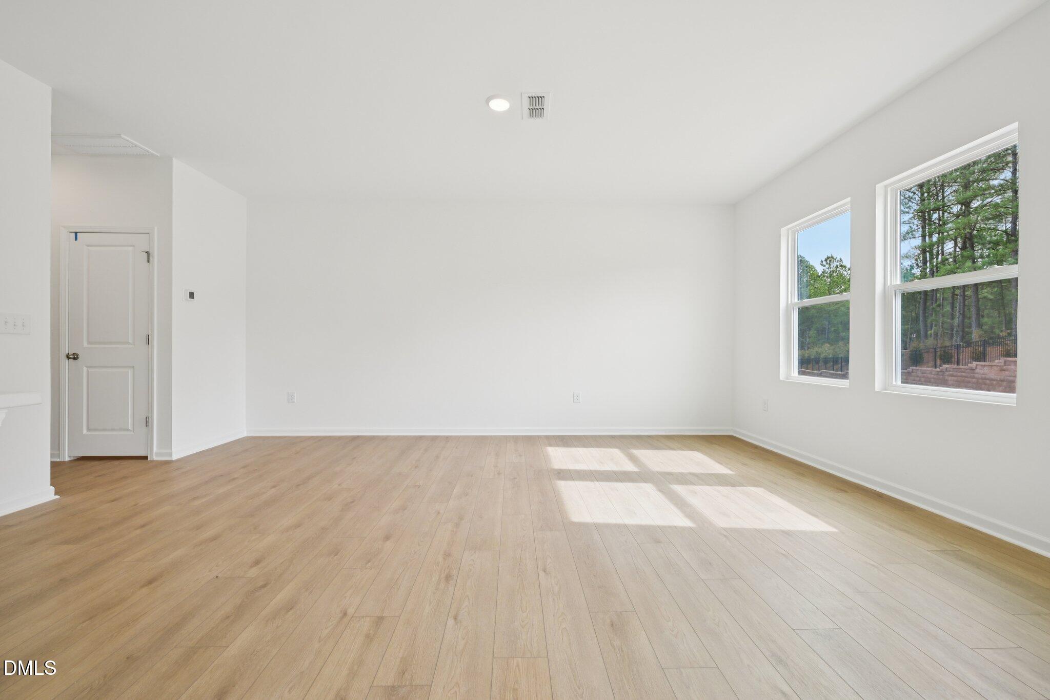 11793 Salers Loop Middlesex, NC 27557 - Photo 14 of 53 wooden floor in an empty room with a window