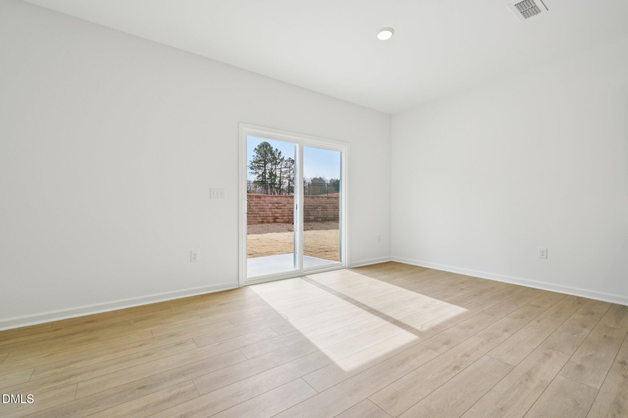 11793 Salers Loop Middlesex, NC 27557 - Photo 15 of 53 an empty room with wooden floor and windows